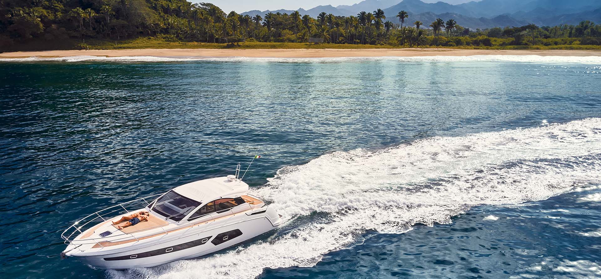 yacht drives away from ocean shore