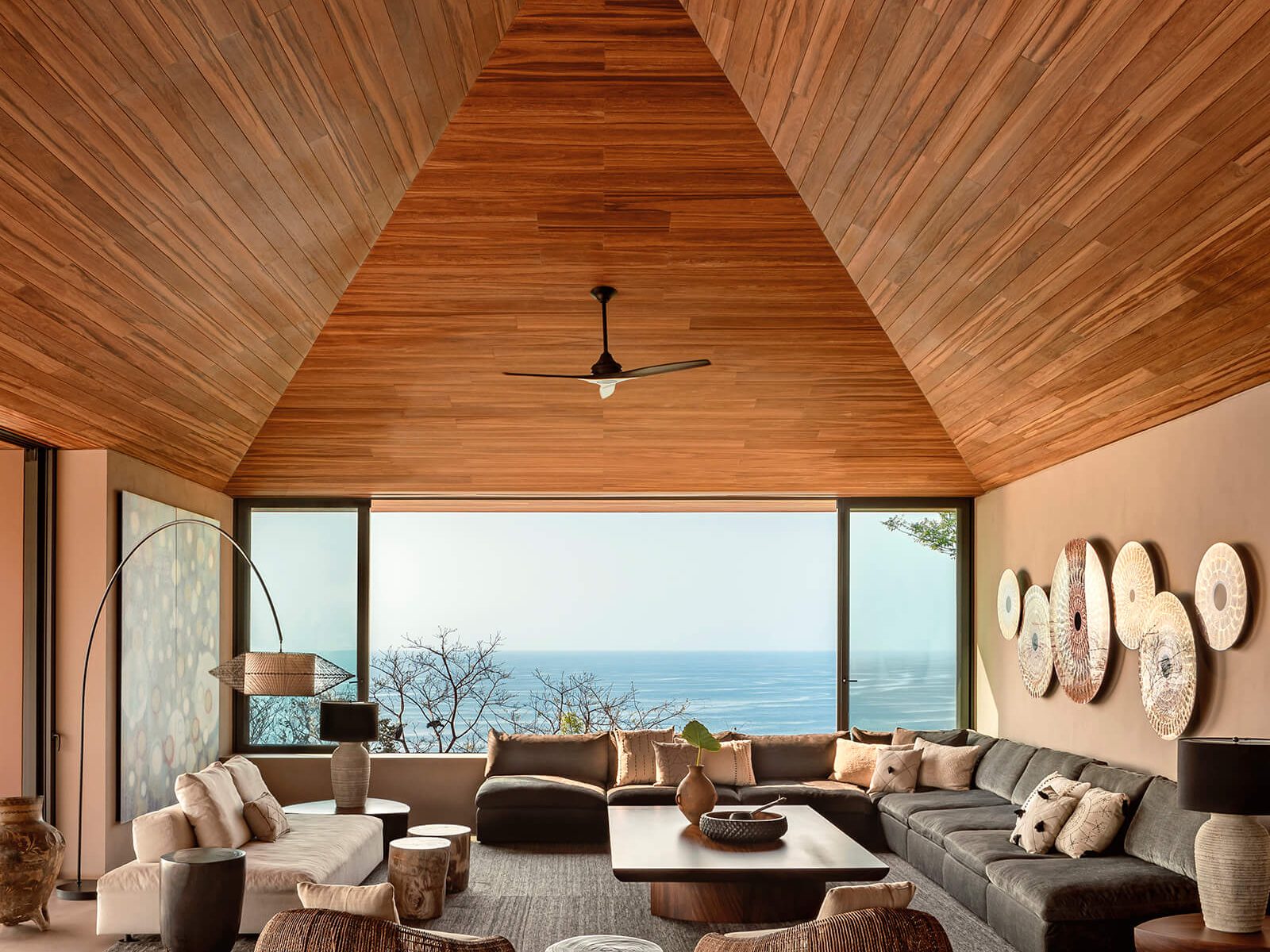 vaulted wood-slat ceiling overlooks ocean from living room