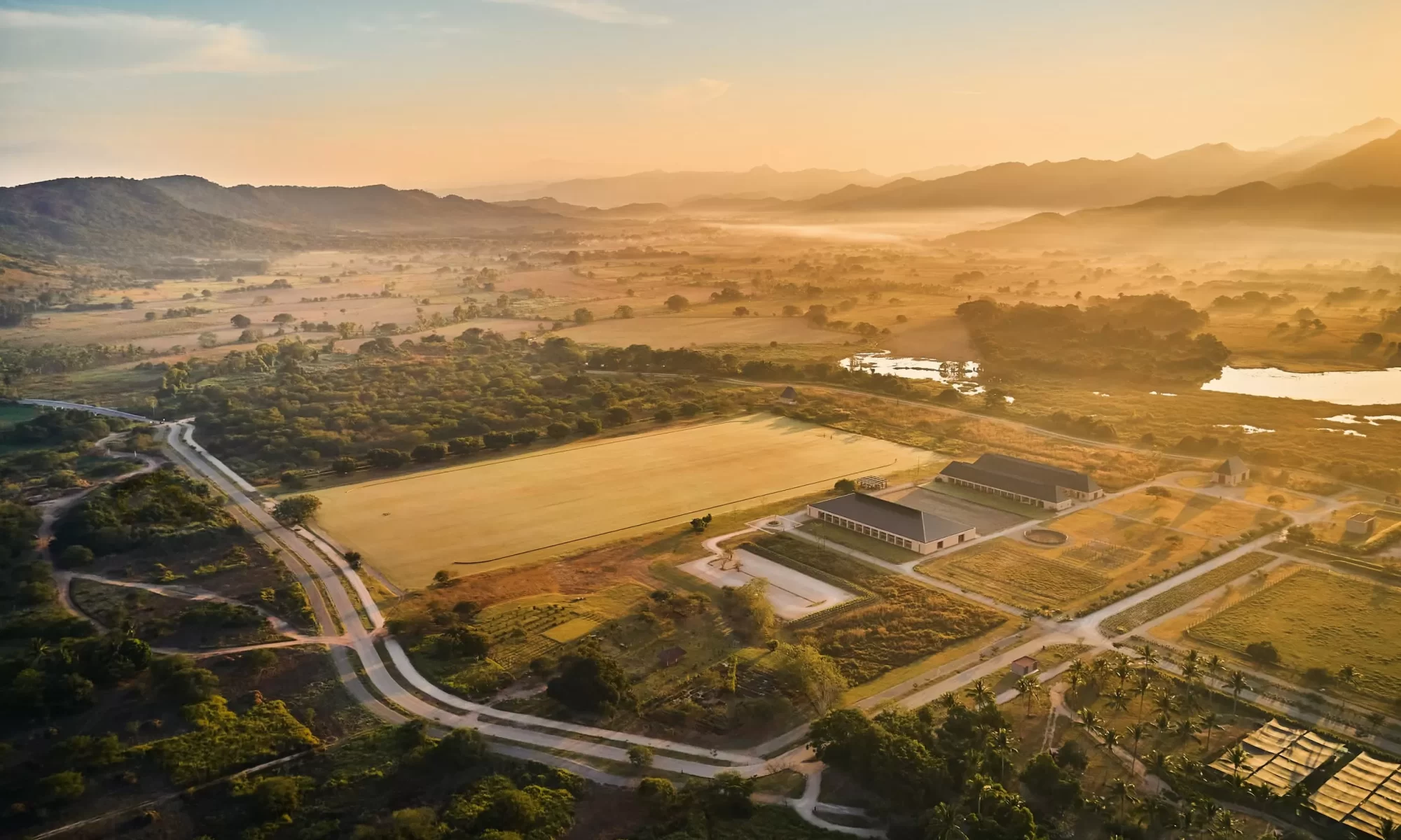 horse barn and polo field during sunrise