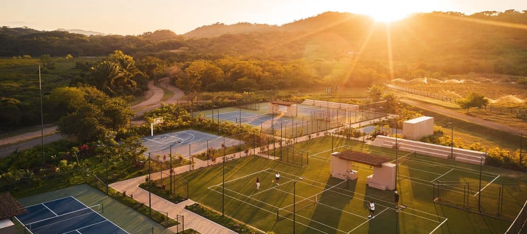 tennis and basketball courts light up at sunset
