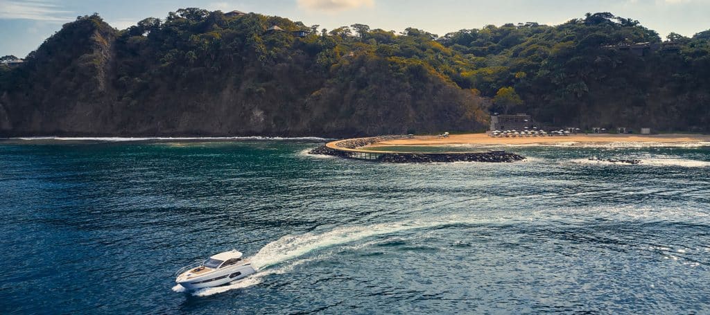 yacht departs mandarina jetty on pacific ocean