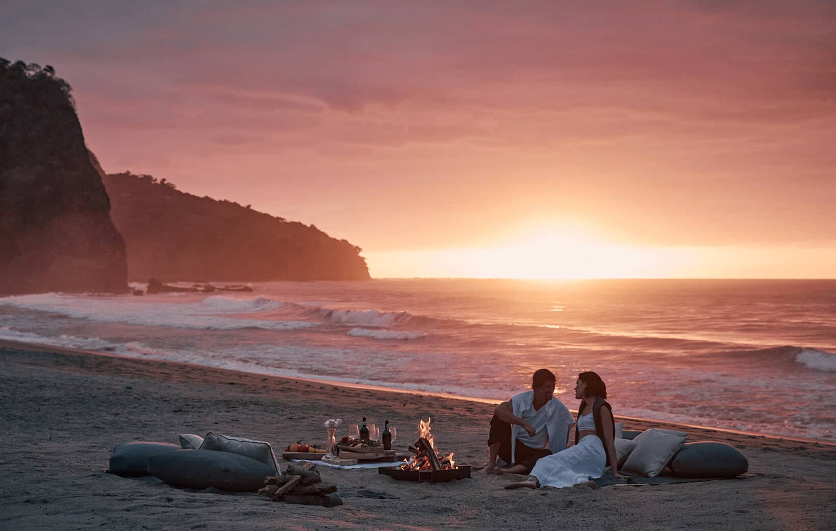 couple dines on provate beach at mandarina sunset