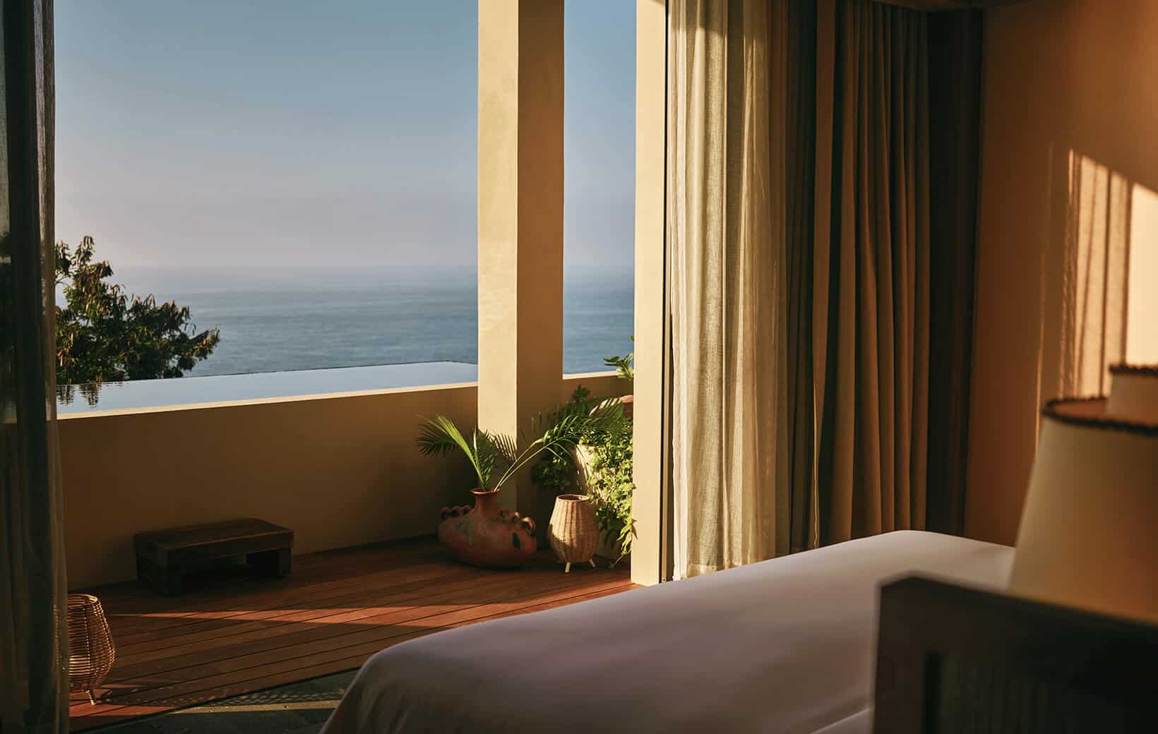 bedroom hotel suite open to private terrace with ocean view